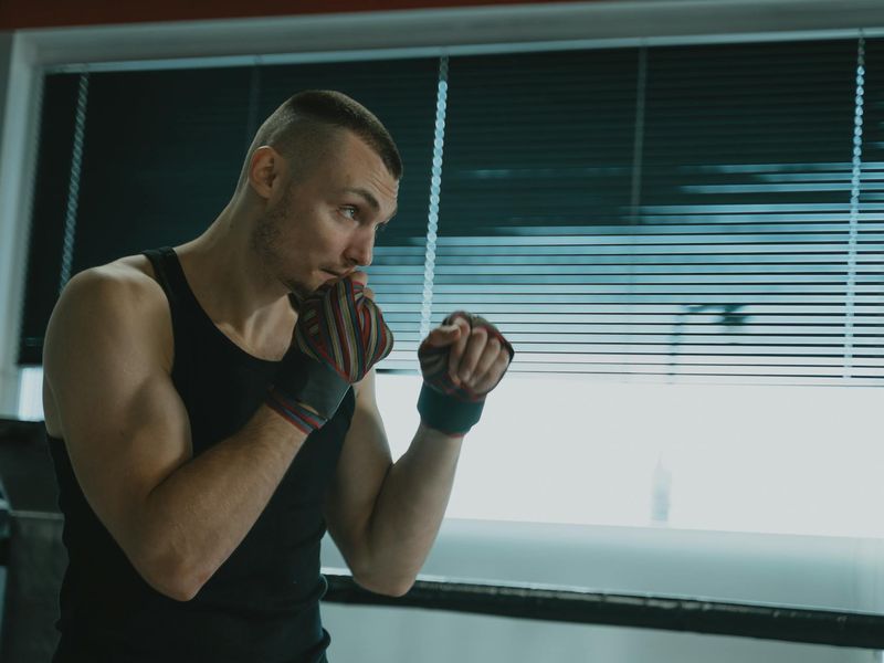 Man in a focused stance during a workout session.